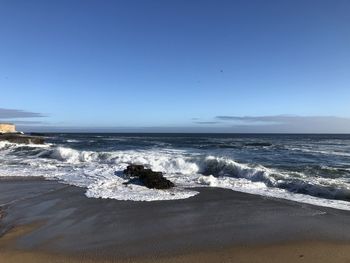 Scenic view of sea against clear blue sky