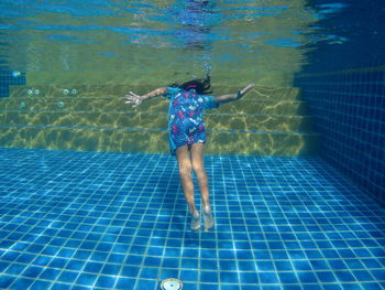 Full length of boy swimming in pool