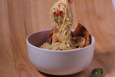 Close-up of noodles in bowl on table