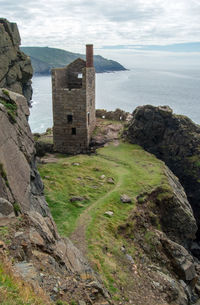 Scenic view of sea by buildings against sky