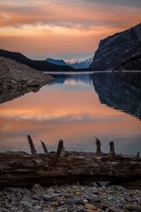 Scenic view of lake against orange sky