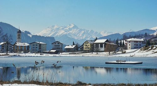 Snow covered mountain against clear blue sky