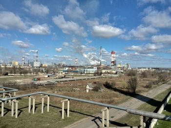 Industrial building against cloudy sky