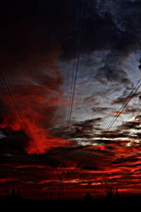 Low angle view of electricity pylon against sky