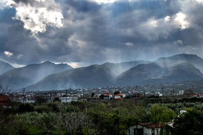 High angle view of houses and mountains against sky