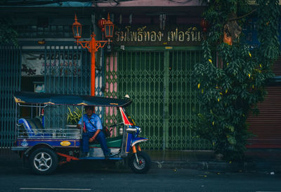 Man cycling on street in city