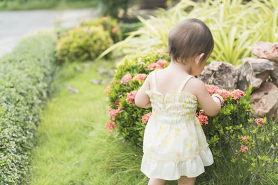 Rear view of woman standing on field