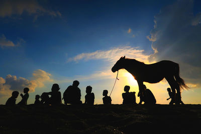 Silhouette of people at sunset