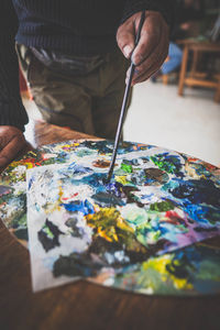 Cropped hand painting on table