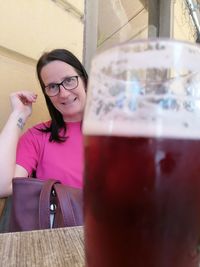 Portrait of smiling woman holding drink