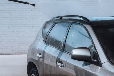 Midsection of man cleaning car in garage