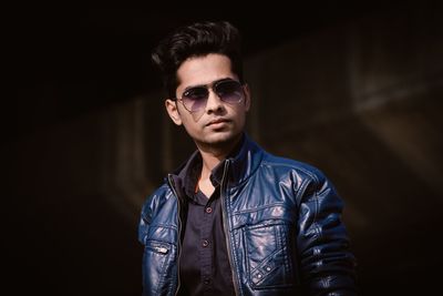 Young man wearing sunglasses while standing outdoors