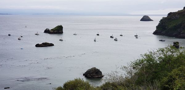 High angle view of rocks in sea against sky