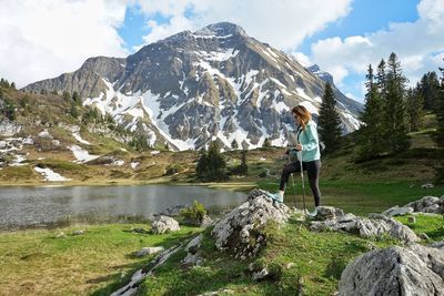 Hiking woman by the alpine lake in austria