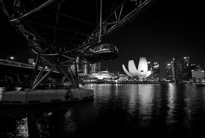Illuminated ferris wheel in city at night