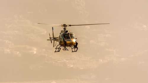 Low angle view of helicopter against sky