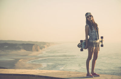 Woman standing on land against clear sky