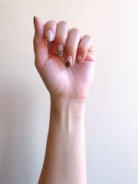 Close-up of woman hand against white background