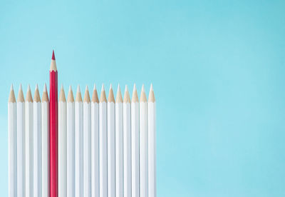 Close-up of colored pencils against blue background