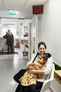 Mother and daughter waiting in doctor's surgery