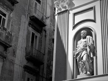 Low angle view of statue against building