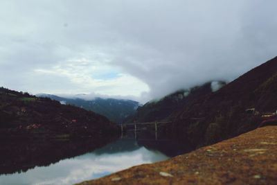 Scenic view of lake against cloudy sky