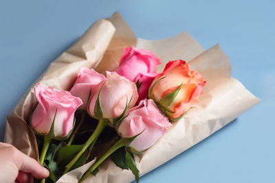 Cropped hand of woman holding bouquet