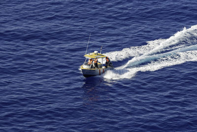High angle view of man on boat in sea
