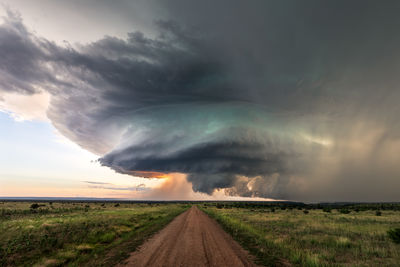 Supercell storm clouds over a field in colorado at sunset