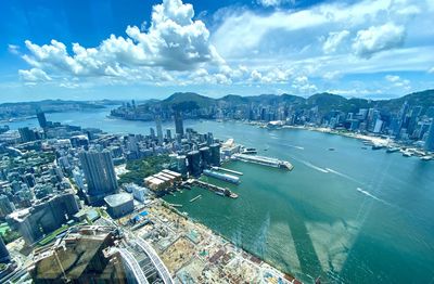 High angle view of city and sea against sky