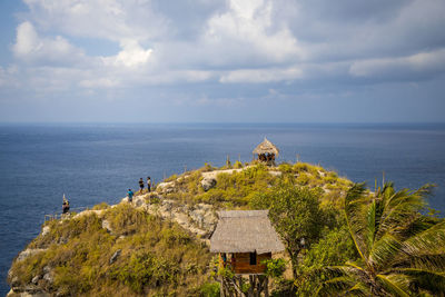 Scenic view of sea by building against sky