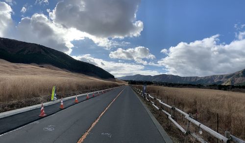 Highway in the mountains.  fields and wheat.  road, track