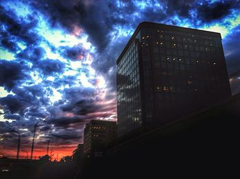 Low angle view of buildings against cloudy sky