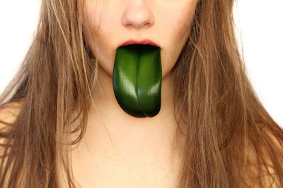 Close-up of woman against white background