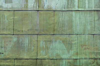 Oxidized copper folded sheet metal on roof. copper wall texture background. with marks and scrawls.