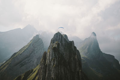 Aerial view of paraglider over mountain range