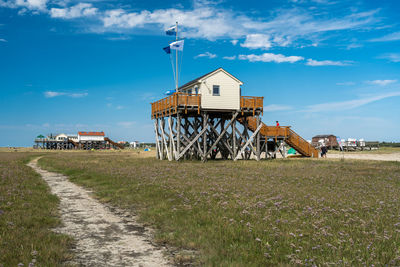 Built structure on field against sky