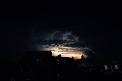 Storm clouds over city at night