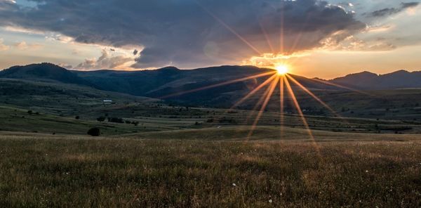 Scenic view of landscape against sky during sunset