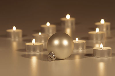 Close-up of christmas decoration with tea light candles on floor