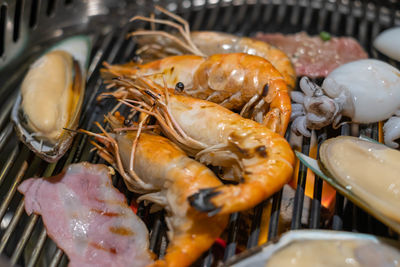 High angle view of fish on barbecue grill