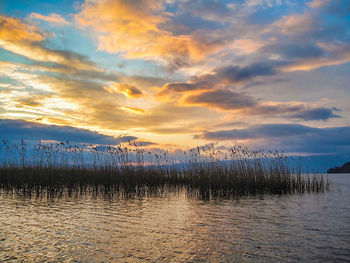 Scenic view of lake against sky during sunset