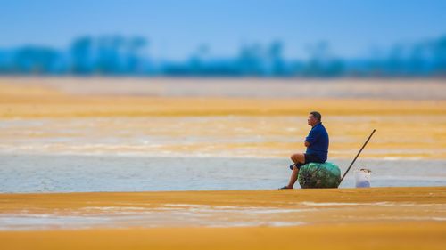 Men sitting on beach