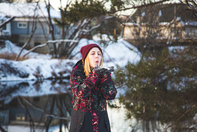 Portrait of woman standing in snow