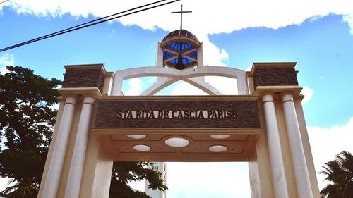 Low angle view of cross against sky