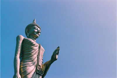 Low angle view of statue against clear blue sky