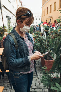 Young woman using smartphone social media sending texts watching photos and videos talking remotely