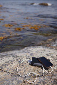 Cell phone and power bank on rocky coast