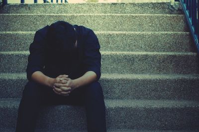 Midsection of woman sitting on steps