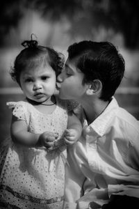 Portrait of cute girl with brother outdoors